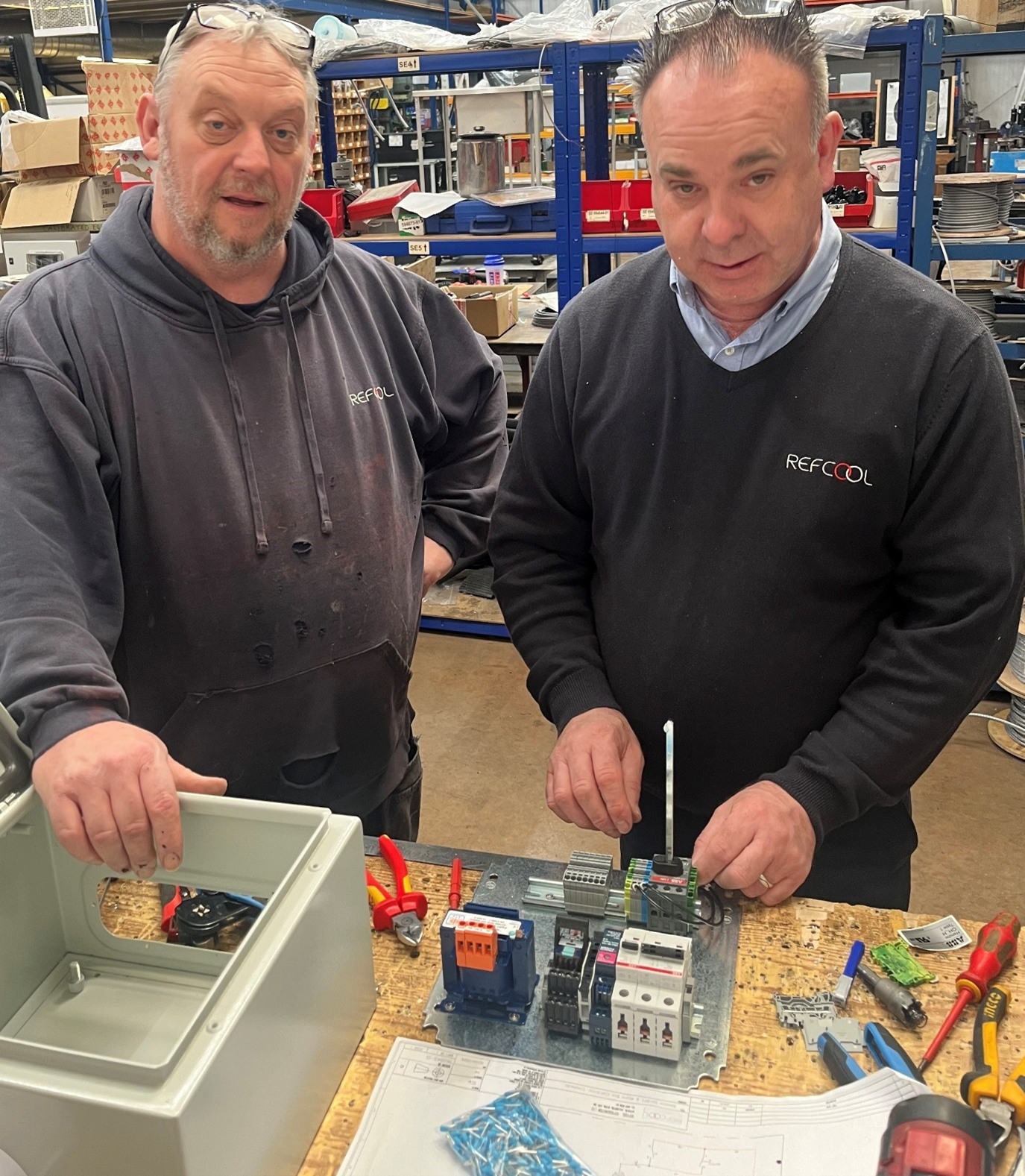 Refcool technicians preparing control systems for installation